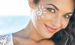 Lady at the beach with white sunscreen on her face