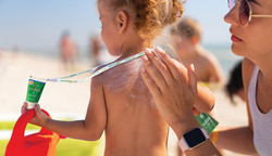 Soleo Organics being applied to a young child at the beach